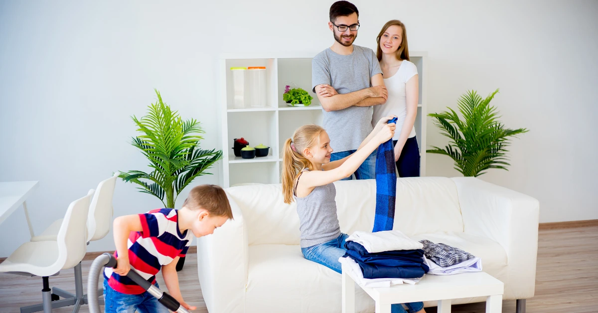 Kids and parents tidying up their living room.